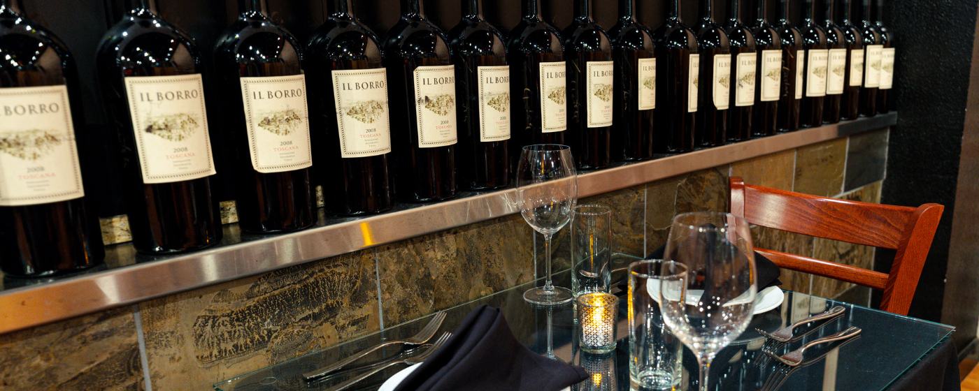 Il Borro bottles lined along the bar at Valeria