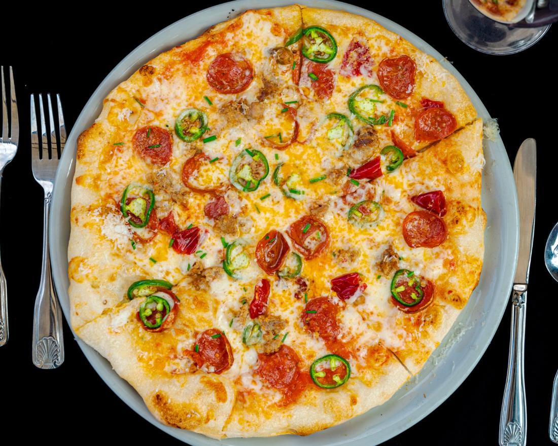Wood-fired pizza with pepperoni, sausage and jalapeño